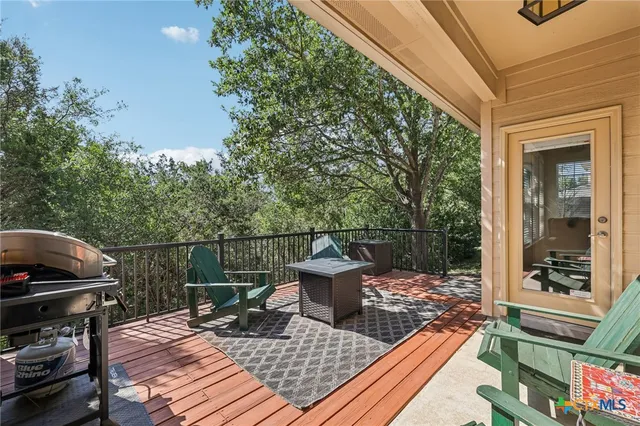 a view of a patio with a table chairs and a potted plant
