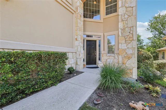 a couple of potted plants in front of door
