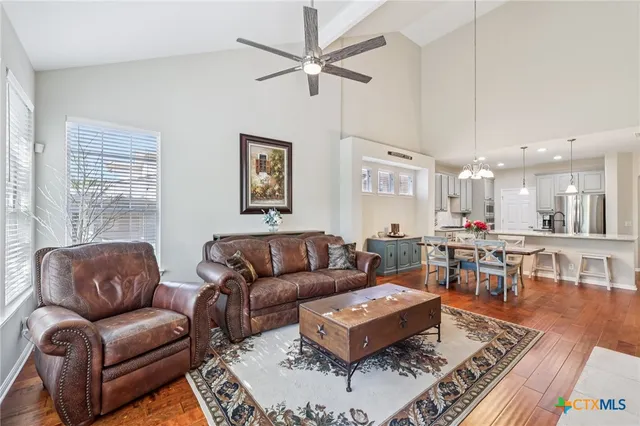 a living room with furniture a rug and a table