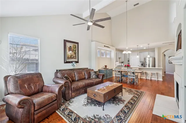 a living room with furniture a rug and a window