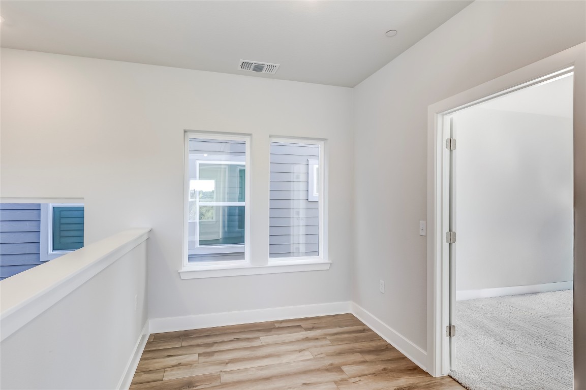 715 Bernese Pass Austin, TX 78745 - Photo 17 of 38 Unfurnished room with baseboards and light wood-style floors