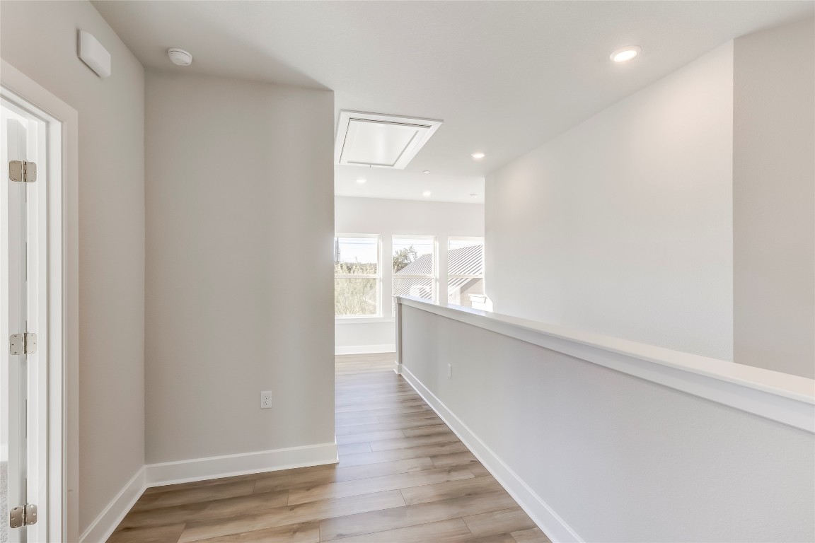 715 Bernese Pass Austin, TX 78745 - Photo 18 of 38 Corridor with attic access, light wood-style floors, and recessed lighting