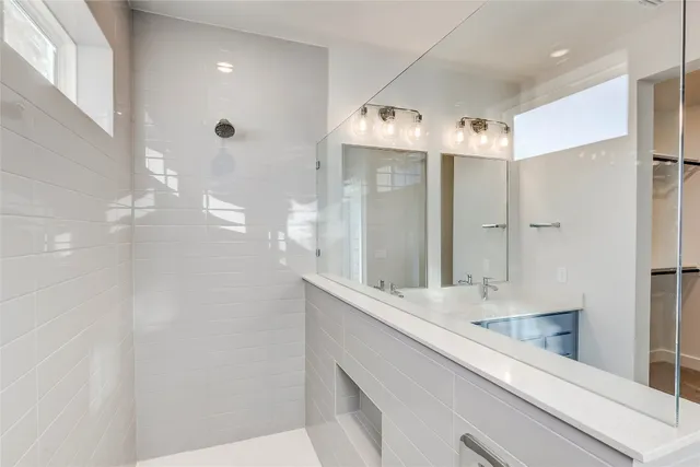 a bathroom with a double vanity sink mirror and
