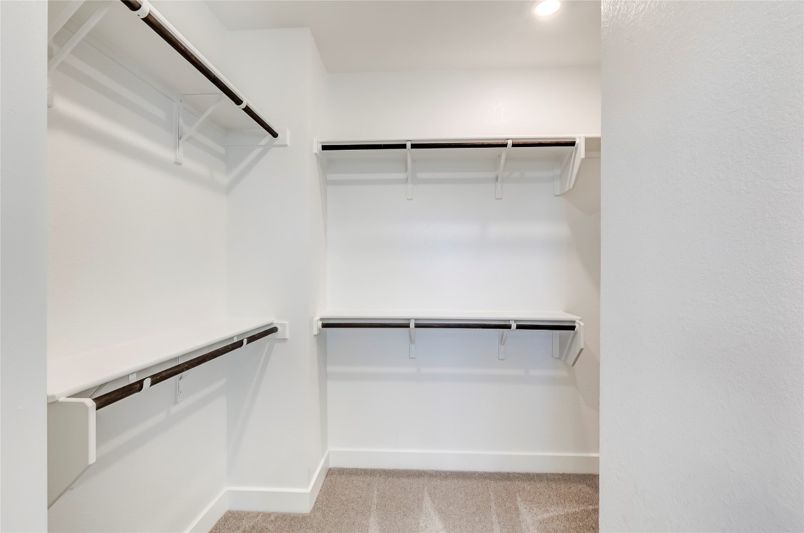 715 Bernese Pass Austin, TX 78745 - Photo 26 of 38 Walk in closet featuring light colored carpet
