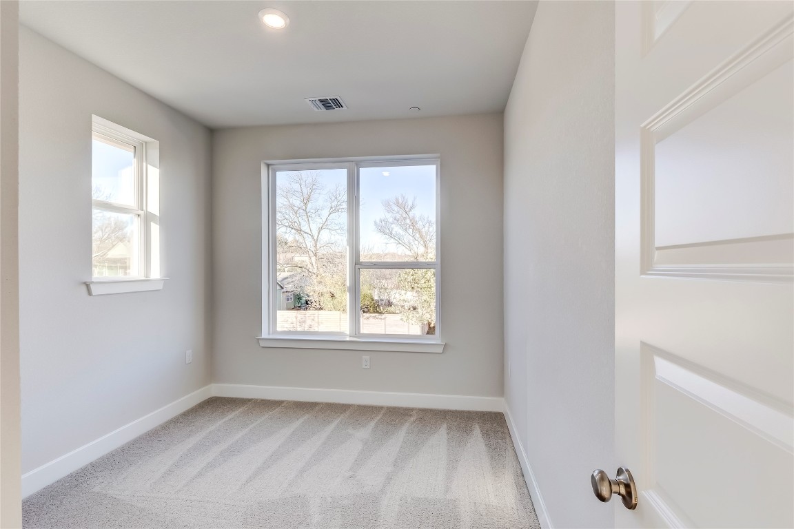 715 Bernese Pass Austin, TX 78745 - Photo 27 of 38 Empty room featuring light colored carpet and recessed lighting