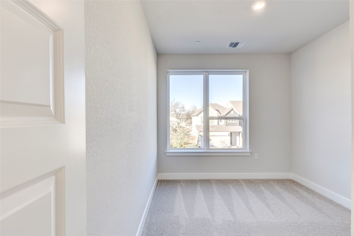 715 Bernese Pass Austin, TX 78745 - Photo 29 of 38 Spare room featuring light colored carpet and baseboards