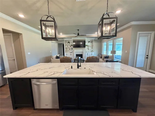 a view of a kitchen with a sink and chandelier