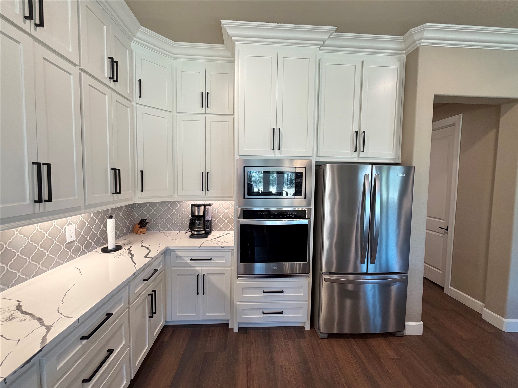 838 Oak Ridge Drive Angleton, TX 77515 - Photo 20 of 49 a kitchen with white cabinets and stainless steel appliances