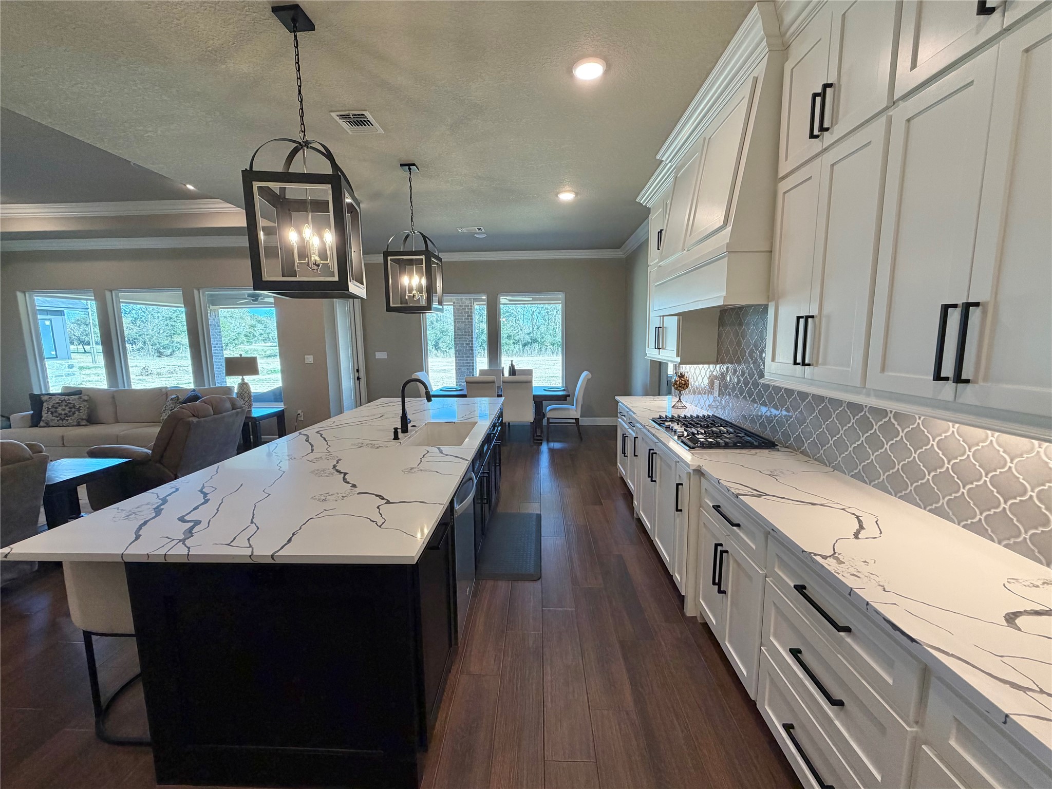 838 Oak Ridge Drive Angleton, TX 77515 - Photo 21 of 49 a large kitchen with stainless steel appliances kitchen island granite countertop a stove a sink dishwasher a dining table and chairs with wooden floor