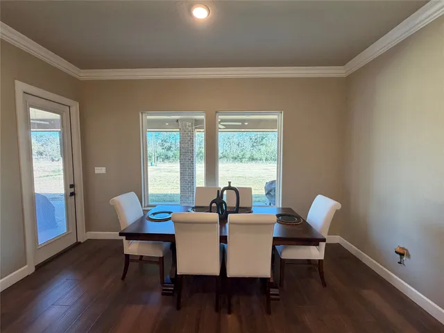 a dining room with furniture and wooden floor