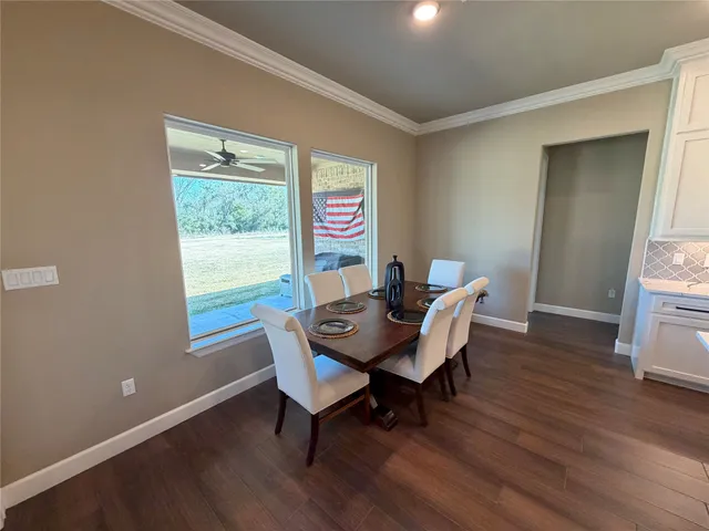 a view of a dining room with a table and chairs