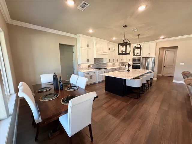 a view of a dining room with furniture and wooden floor
