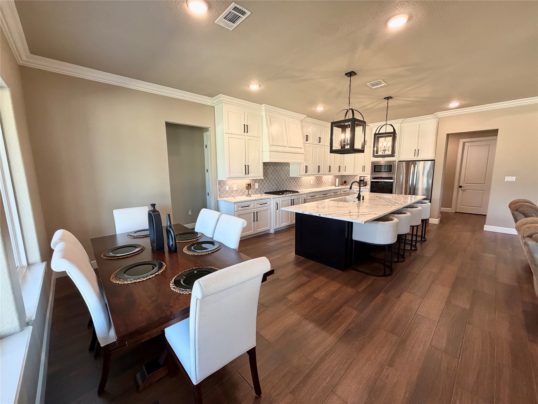838 Oak Ridge Drive Angleton, TX 77515 - Photo 24 of 49 a view of a dining room with furniture and wooden floor