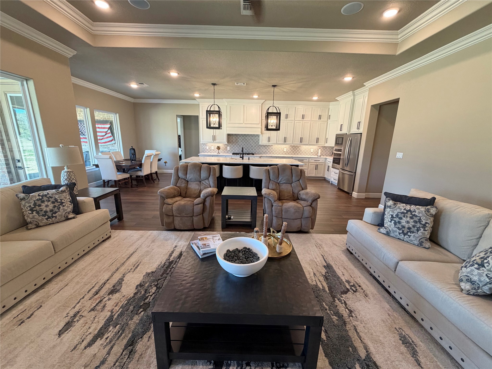 838 Oak Ridge Drive Angleton, TX 77515 - Photo 30 of 49 a living room with furniture a kitchen view and a chandelier