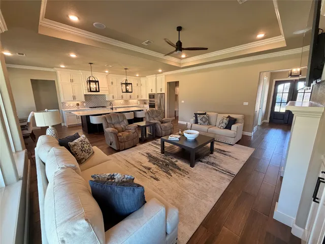 a living room with furniture and a wooden floor