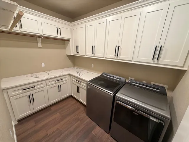 a kitchen with granite countertop white cabinets and white appliances