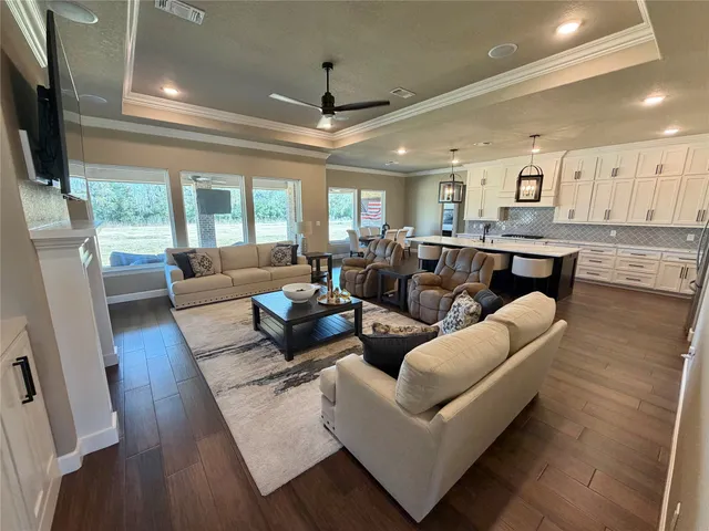 a living room with furniture wooden floor and a flat screen tv