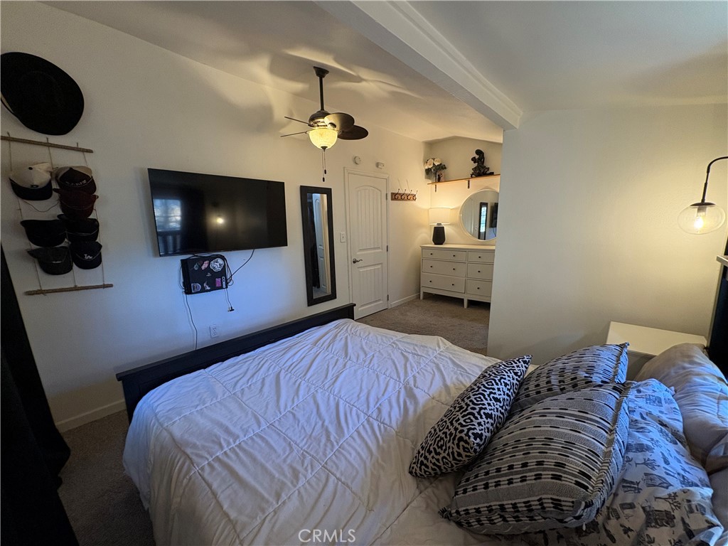 36750 Hilltop Road Yucaipa, CA 92399 - Photo 23 of 27 a bedroom with a bed and a flat screen tv