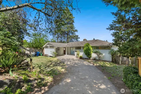 a view of a house with a yard and tree s