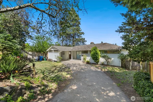 a view of a house with a yard and tree s