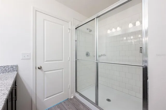 a bathroom with a glass shower door