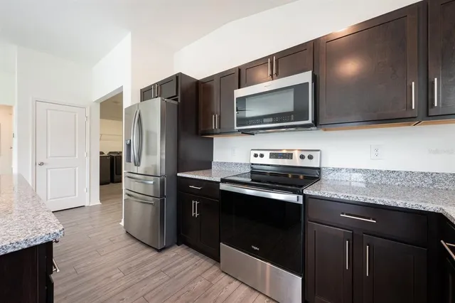 a kitchen with stainless steel appliances and wooden cabinets
