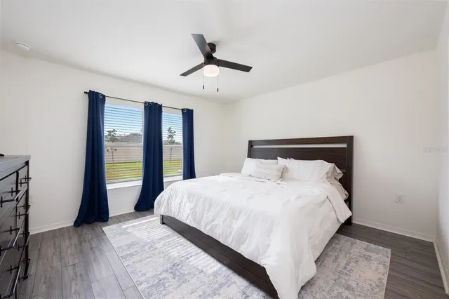 a bedroom with a large bed and a large window