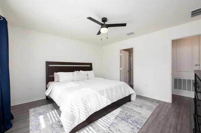 a bedroom with a bed a desk and chair