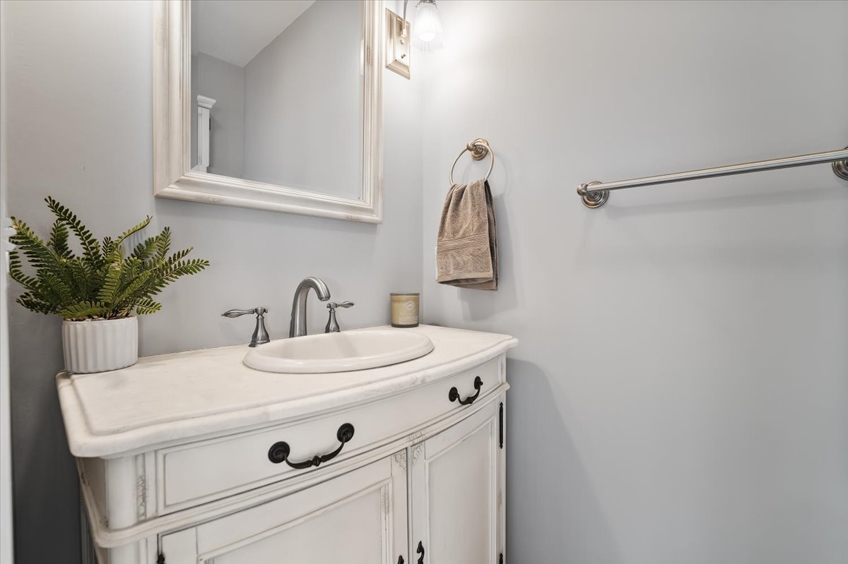 415 Bradley Lane Normal, IL 61761 - Photo 11 of 28 a bathroom with a sink and a mirror