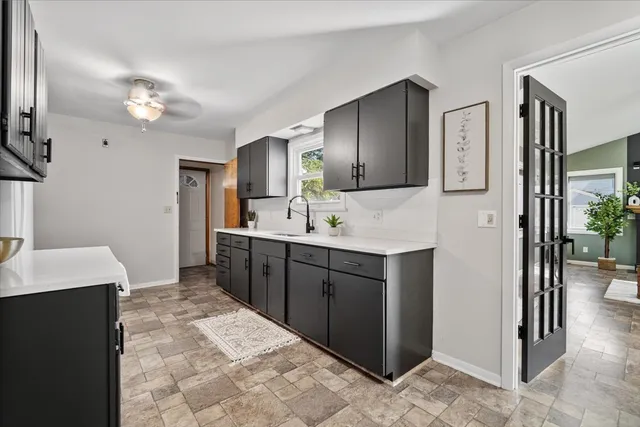 a spacious bathroom with a double vanity sink a mirror and a shower