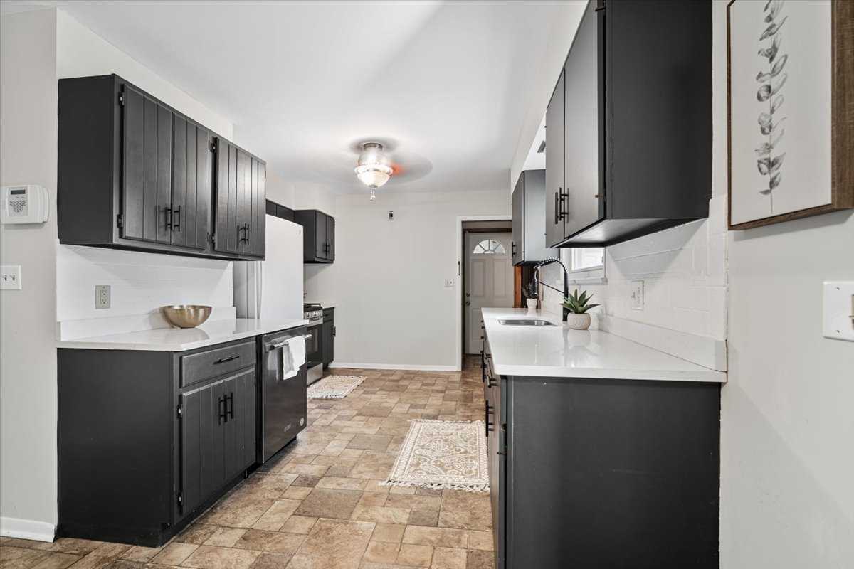 415 Bradley Lane Normal, IL 61761 - Photo 13 of 28 a kitchen with stainless steel appliances granite countertop a sink stove and refrigerator