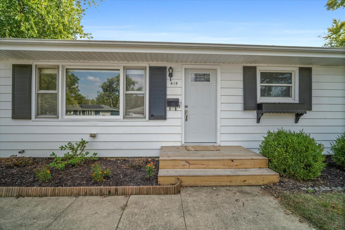 415 Bradley Lane Normal, IL 61761 - Photo 2 of 28 a view of a house with potted plants and a bench