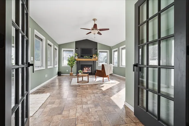 a view of a livingroom with furniture and a ceiling fan