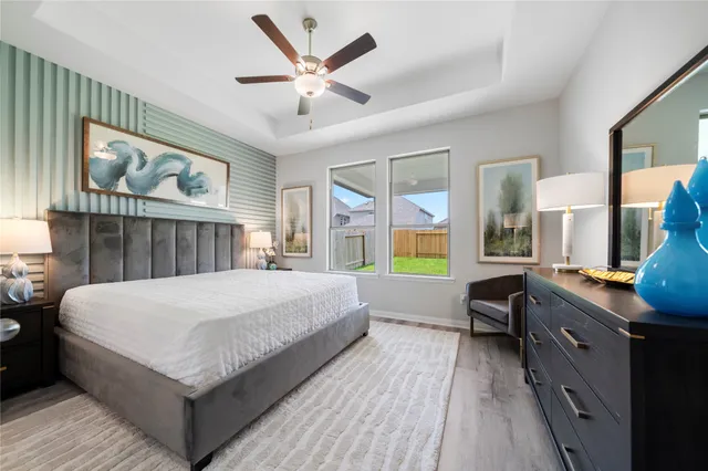 a spacious bedroom with a bed and a large window