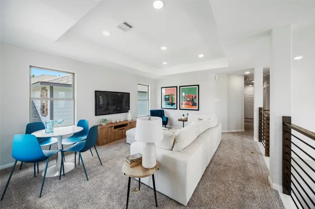 a living room with furniture a rug and a flat screen tv