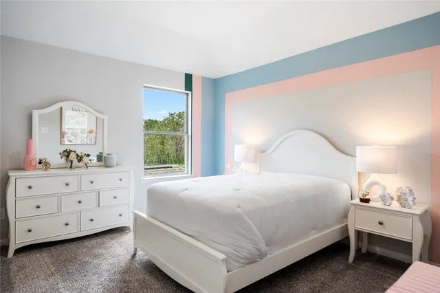 a bedroom with a bed and a dresser