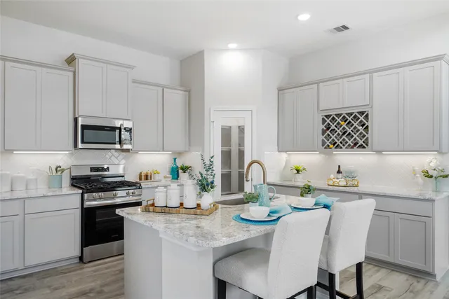a kitchen with a sink stove and microwave