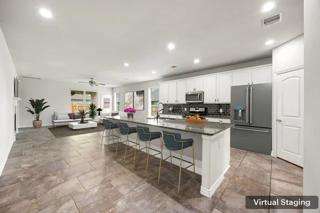 a kitchen with stainless steel appliances granite countertop a refrigerator and a sink