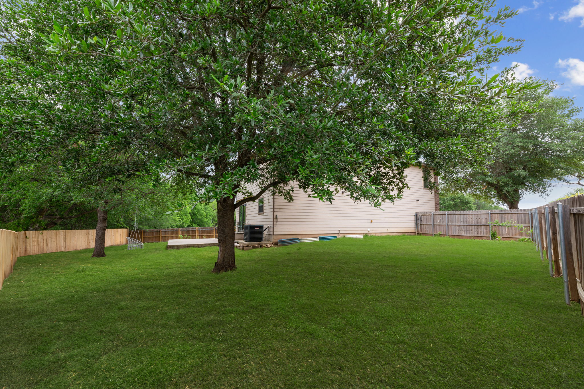 310 Myrtle Street Kyle, TX 78640 - Photo 28 of 40 Expansive green lawn featuring mature trees. (green grass photography)