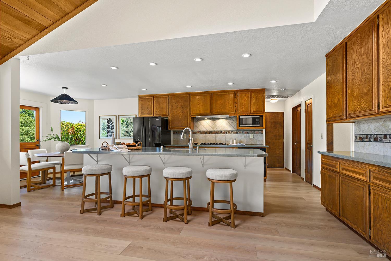 7595 Giusti Road Forestville, CA 95436 - Photo 11 of 41 a kitchen with stainless steel appliances kitchen island granite countertop a table and chairs in it