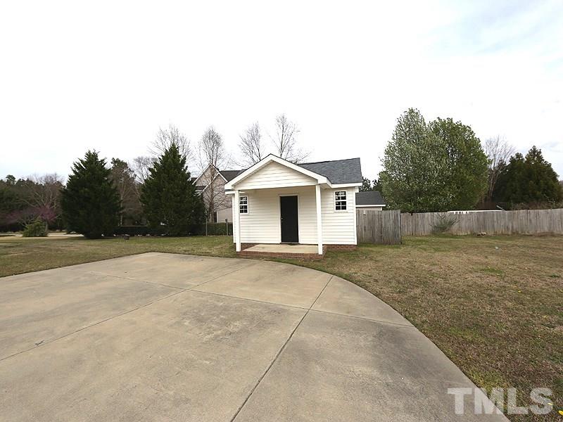 1009 Fieldgrass Place Raleigh, NC 27603 - Photo 12 of 12 a front view of a house with a yard and garage
