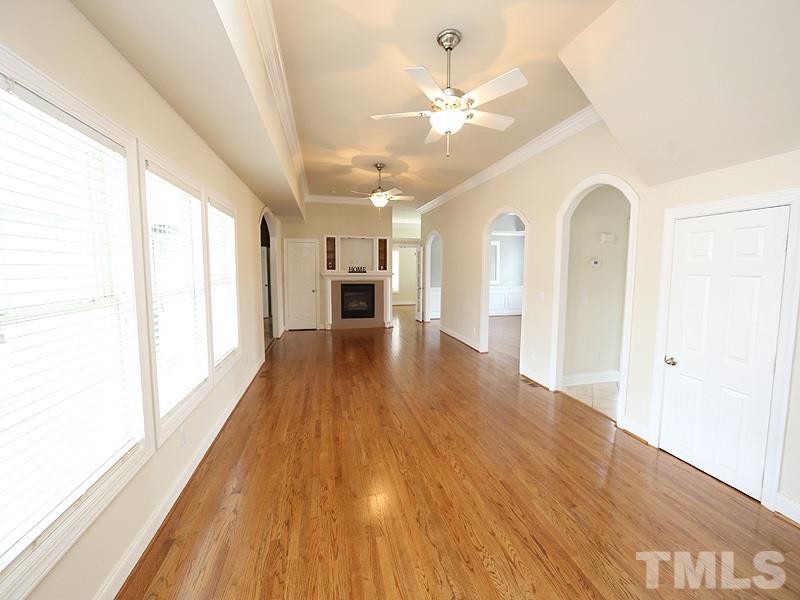 1009 Fieldgrass Place Raleigh, NC 27603 - Photo 3 of 12 a view of empty room with wooden floor and fan
