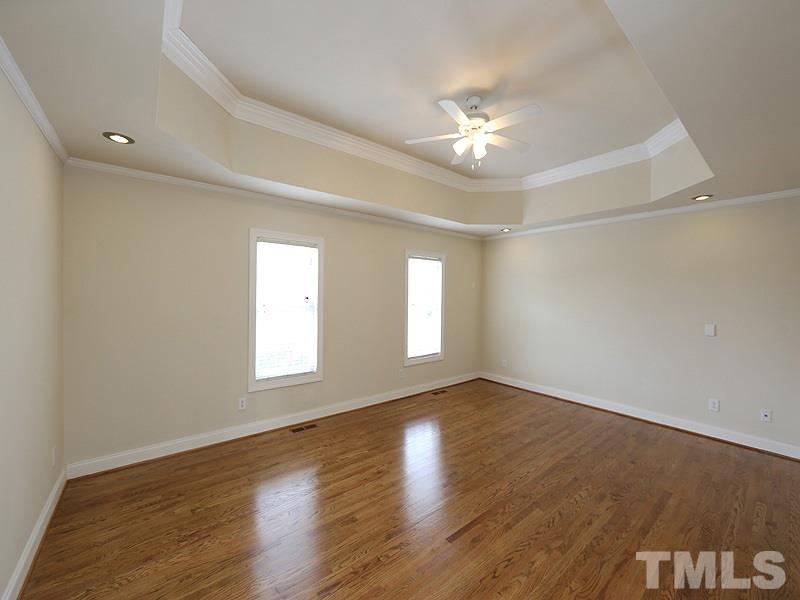 1009 Fieldgrass Place Raleigh, NC 27603 - Photo 6 of 12 wooden floor in an empty room with a window