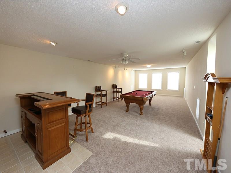 1009 Fieldgrass Place Raleigh, NC 27603 - Photo 10 of 12 a room with furniture and a window