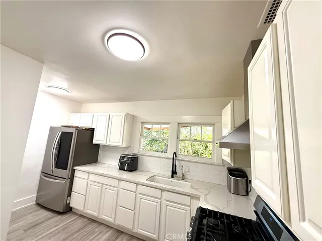 a kitchen with a sink appliances and a window