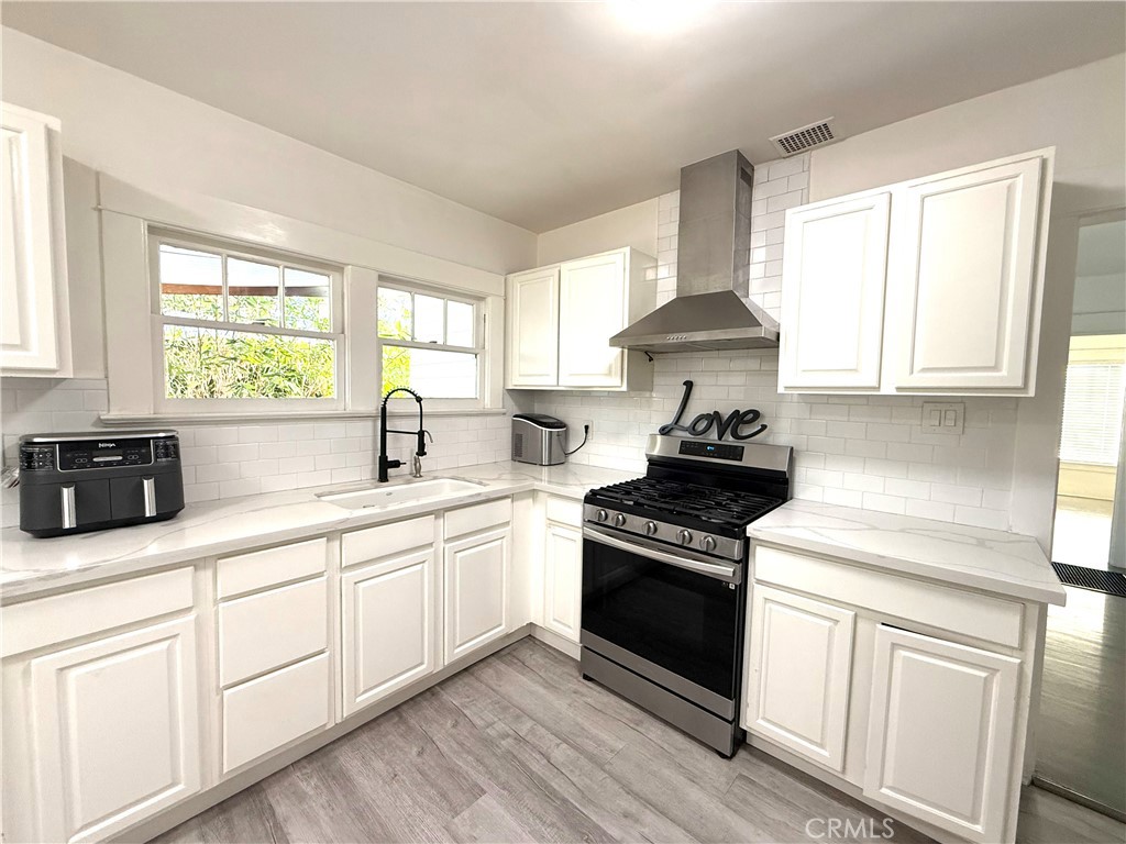 6226 Washington Whittier, CA 90601 - Photo 4 of 21 a kitchen with a stove a sink and a window
