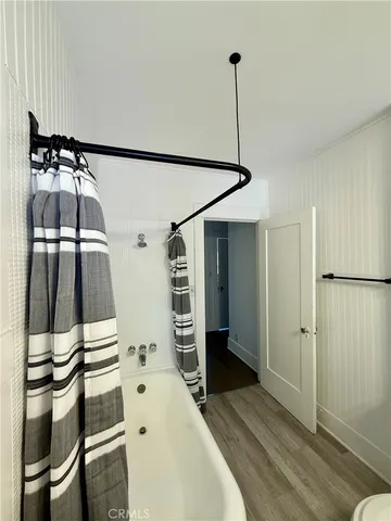 a hallway with a white stove top oven and cabinets