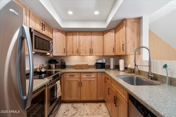 a kitchen with sink refrigerator dining table and chairs