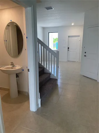 a bathroom with a double vanity sink and a mirror