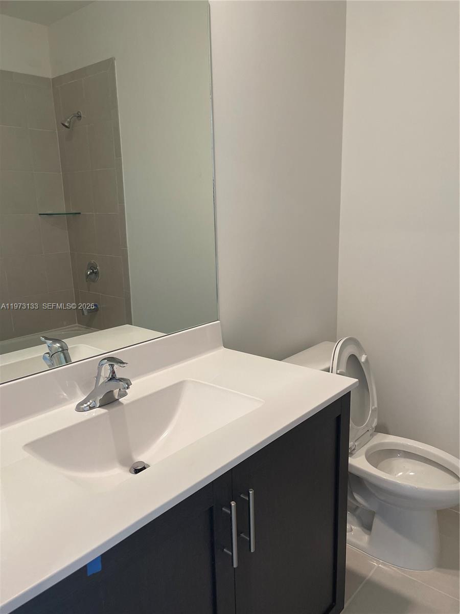 20564 Northeast 5th Place Miami, FL 33179 - Photo 13 of 38 a bathroom with a sink and a toilet